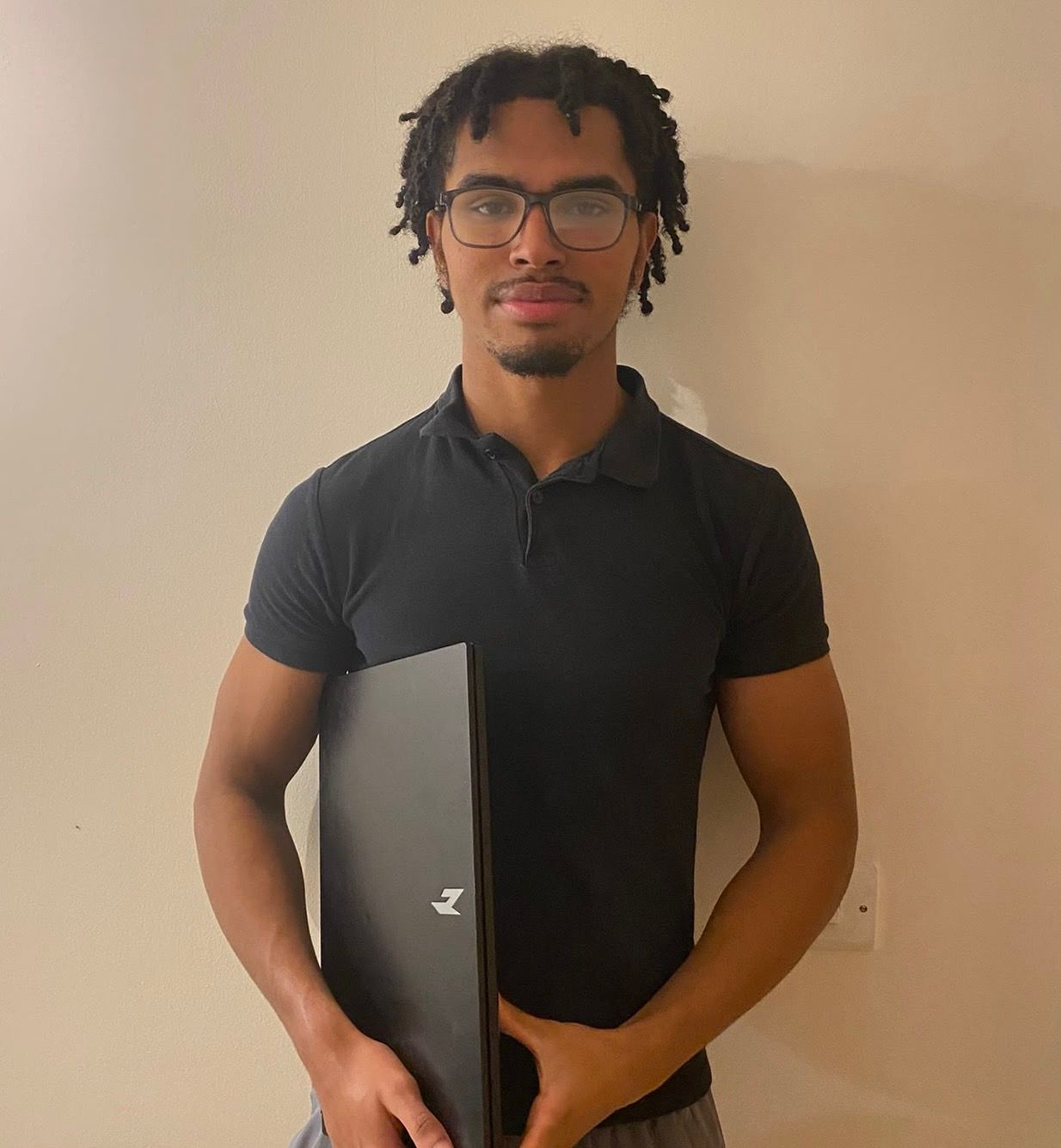 AJ Jennings, owner of TradeFlow, holding a laptop